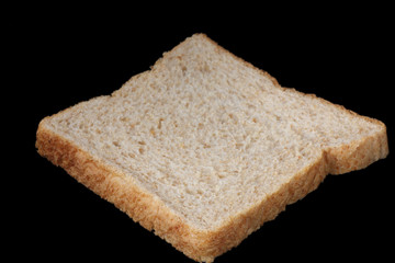 slice of bread over black background