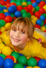 Fototapeta na wymiar happy girl in ball pool