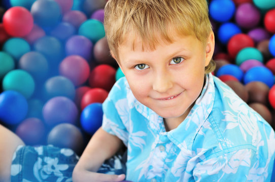 boy in pile of balls