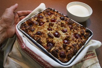 Soufflé with bread and cherries, fresh oven-baked pastries, served by the cook