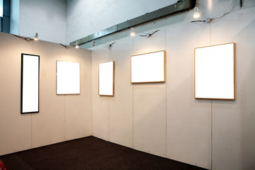 empty frames in a room against a white wall .