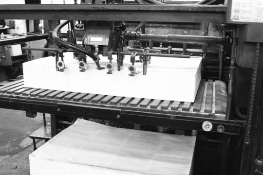 An old offset printing machine in black and white