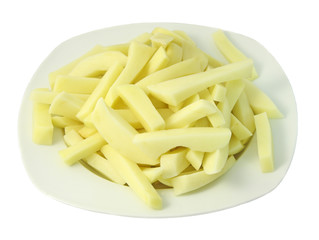 Plate of raw french fries isolated on white