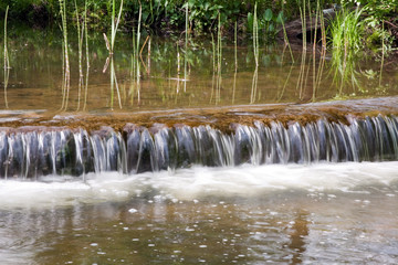 water falls in forest river