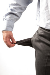 Disappointed businessman with empty pockets isolated over white