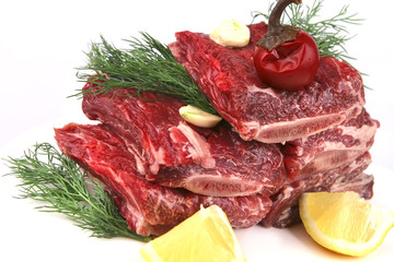 ribs with lemon and greenery on white