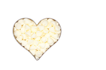 white chocolate morsels fill a silver heart