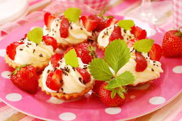 mini tartlets with whipped cream and strawberry