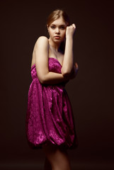 Seductive young woman wearing pink dress