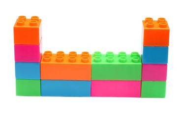 Fototapeta premium Colorful plastic toy bricks make structure