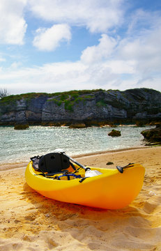 Sea kayak on the shore with scenic background