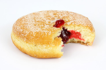 Fresh raspberry filled donut that has been bitten