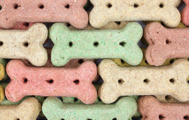 Several rows of different colored dog biscuits