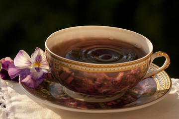 flavored tea in a porcelain bowl and a flower