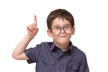 Little boy in funny round spectacles raising finger