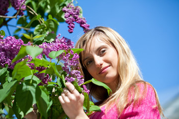 Young woman with lilac flowers