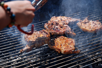 barbecue with steaks on the grill