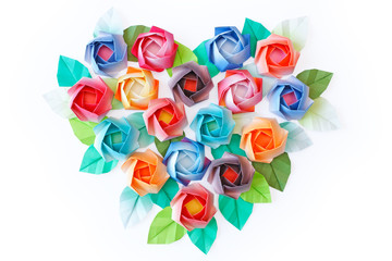 Paper roses arranged in a heart shaped on a white background