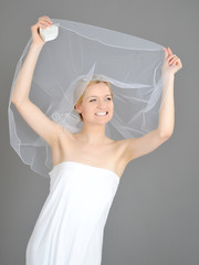 young beautiful bride covered in veil