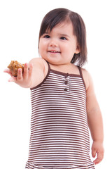 Little girl outstretching a sea shell in her hand