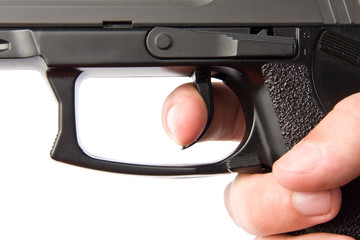 Pushing the handgun trigger