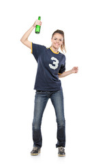 Female sport fan celebrating with a beer bottle in her hand