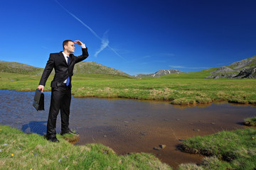 A businessman in a suit searching for a way