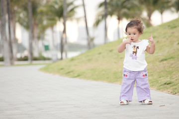 Toddler touching her nose