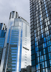 Naklejka premium Highrise glass building with sky and clouds reflection