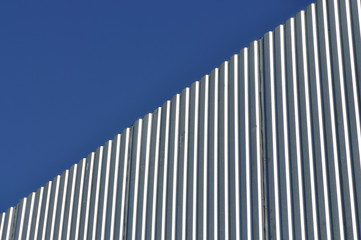 Aluminum fence against blue sky, diagonal view