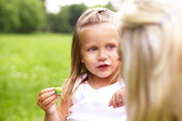 a little girl is talking with her mother