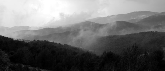 Fog on black and white mountains panorama landscape
