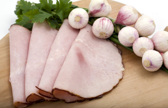 Slices Of Ham On Wooden Plate And Garlic