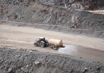 A Quarry Tractor Towing a Dust Suppression Sprayer.