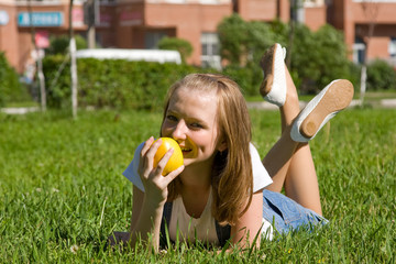 Teenage girl with a yellow apple