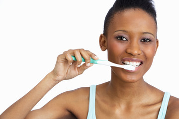 Young Woman Brushing Teeth In Studio