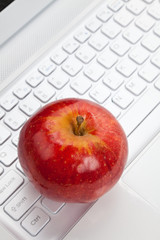 Computer Keyboard and red apple