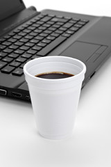Coffee cup and computer