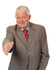 Successful mature businessman offering handshake