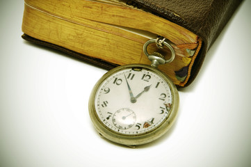 ancient book and pocket watch