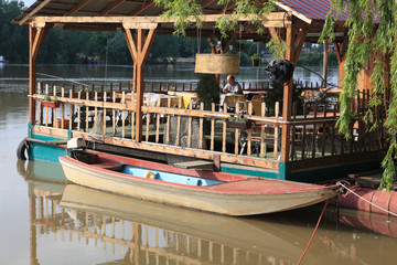 Fototapeta na wymiar River scene cafe on boat