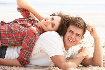Romantic Young Couple Relaxing On Beach