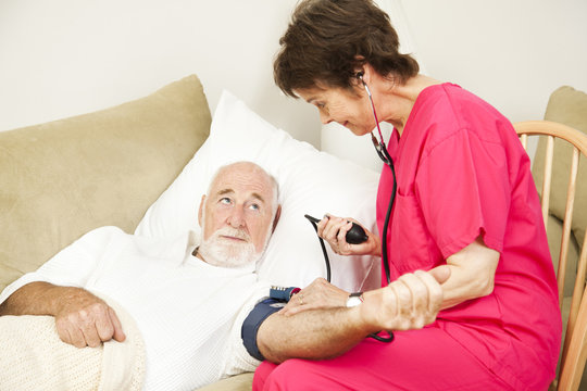 Home Health Nurse Takes Blood Pressure
