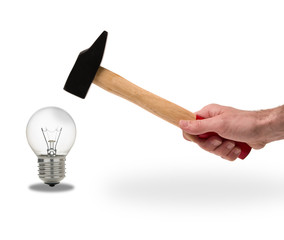 hammer breaking electric bulb on white