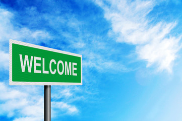 'Welcome' sign against a bright blue sky. With space for your te
