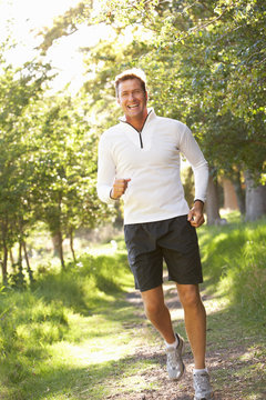 Middle Aged Man Jogging In Park