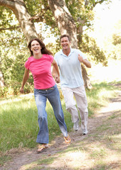 Portrait Of Young Couple Walking In Park