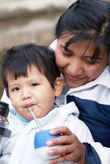 Portrait of a Latin family drinking a mate in the street