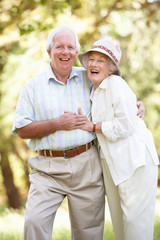 Senior Couple Walking In Park