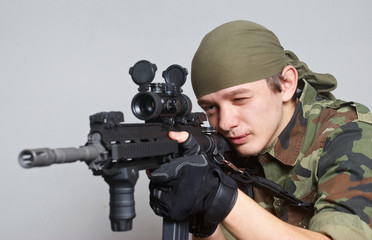Portrait of the soldier with an automatic assault rifle